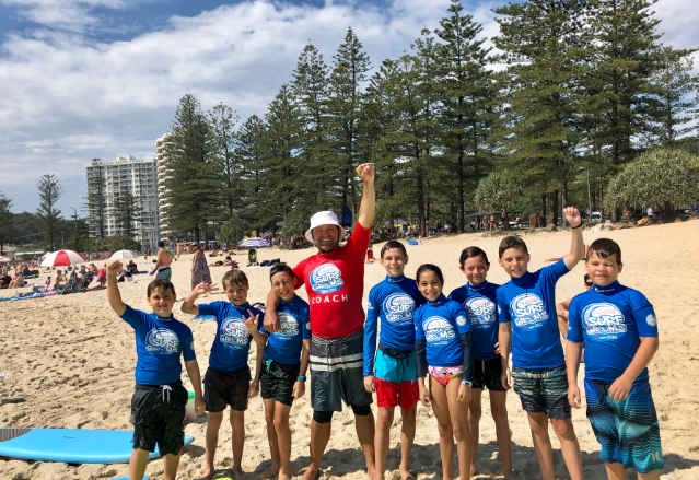 surf lesson group at burleigh beach enjoying water activities gold coast visitors love during spring holidays