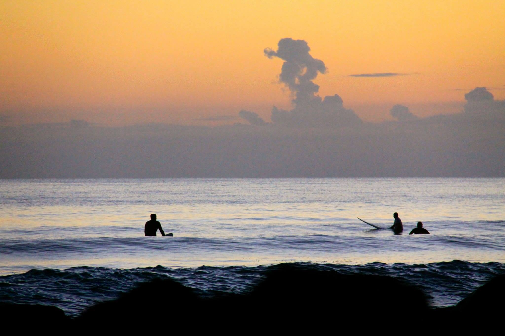 burleigh-heads-early-mornings Surfers in the water at daybreak as the sun rises over the ocean on the Gold Coast