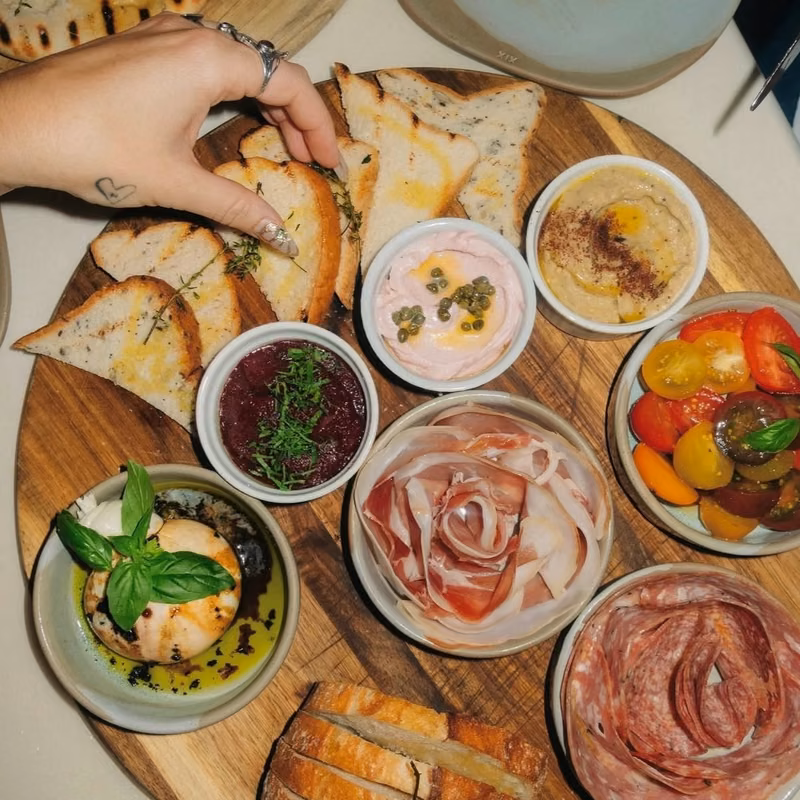 Instagram post by The Village at Burleigh, tile 2 Shared platter of breads, dips and cured meats at Maman Bar and Kitchen on James Street, Burleigh Heads