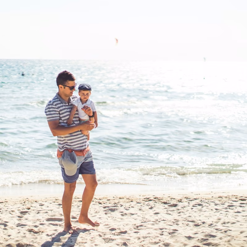 Instagram post by The Village at Burleigh, tile 5 Father and young child paddling at the water's edge on the Gold Coast, a short stay from The Village at Burleigh